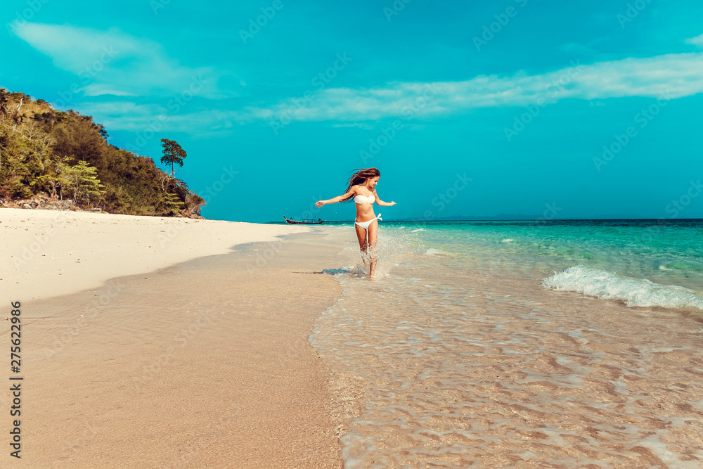 Beautiful emotional Model Girl walking alonh the beach and laughing. Beautiful Woman Hot Girl enjoying the Ocean. Tropical vacation. Beautiful emotional Model Girl walking alonh the beach and laughing. Beautiful Woman Hot Girl enjoying the Ocean. Tropical vacation.