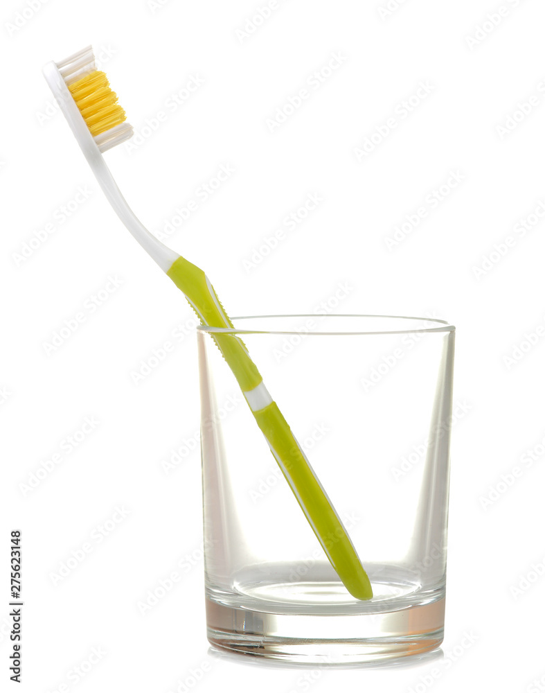 Multi-colored toothbrushes in a glass beaker on a white isolated background. Oral hygiene. Multi-colored toothbrushes in a glass beaker on a white isolated background. Oral hygiene.