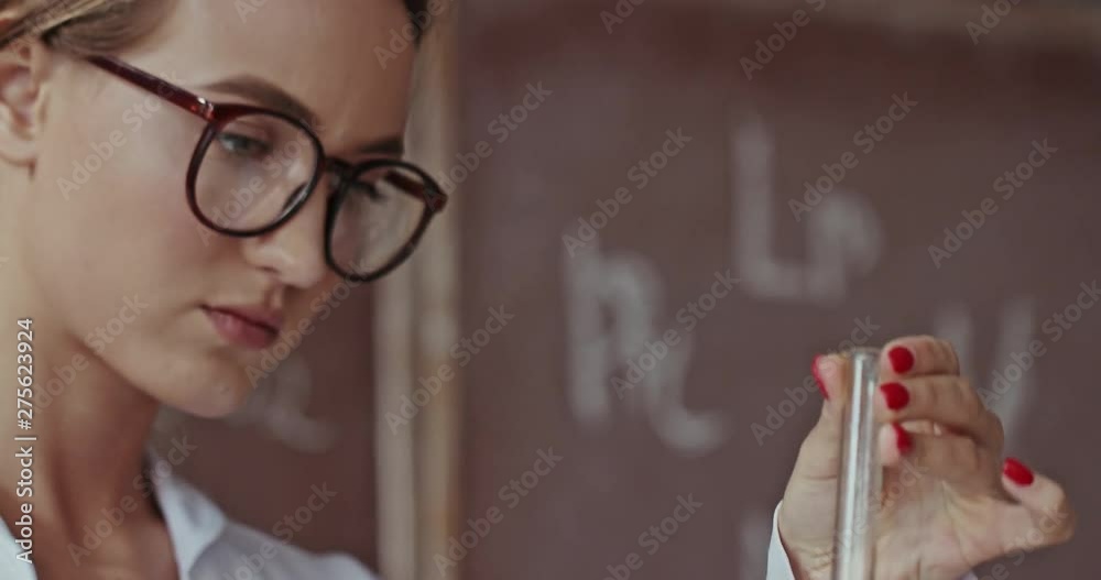 Young female scientist or chemist working in a lab