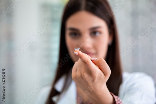 Contact lens on female finger, close up view. Medicine and vision concept
