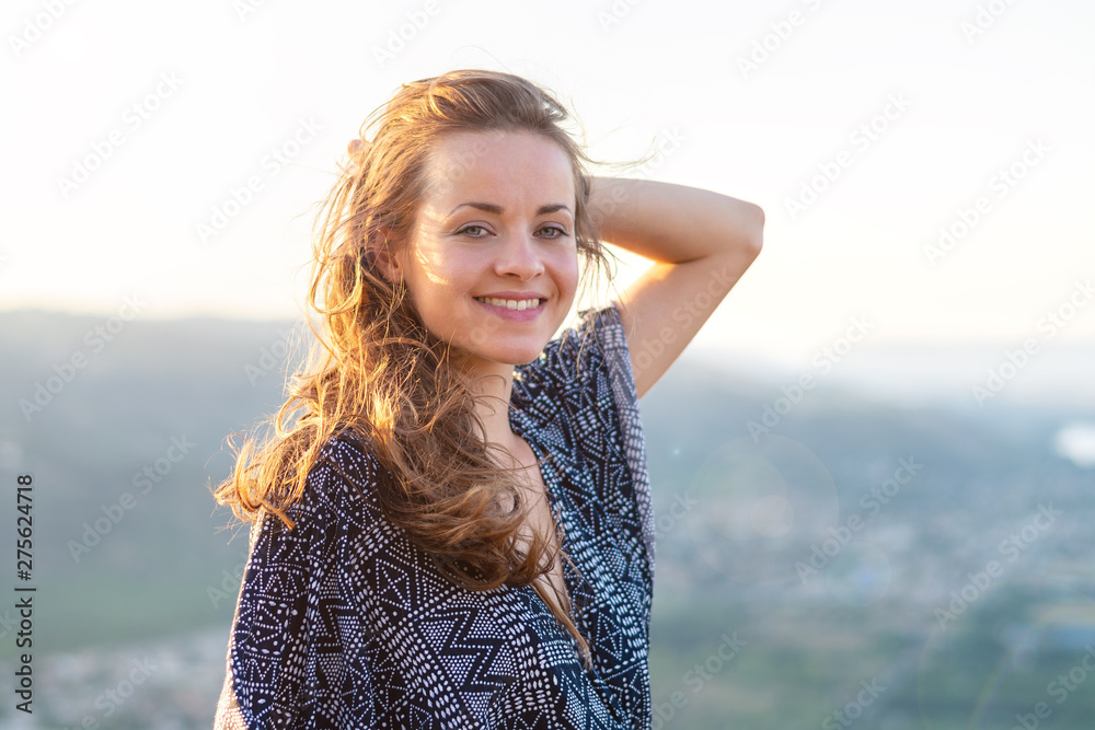 Young woman portrait. Young woman with sexy dress at sunset. Rhone valley in the background.