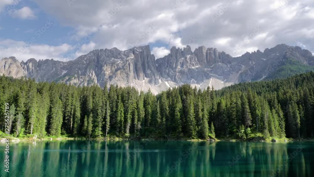Green emerald lake in front of mountains - Lago di Carezza (Karersee) in South Tyrol, Italy in the summer