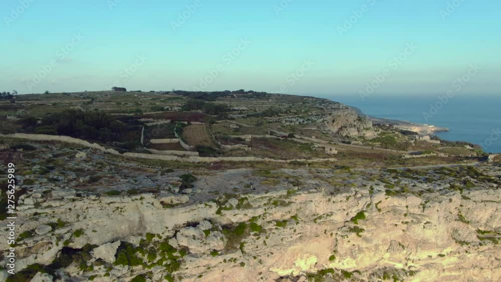 Dingli cliffs, Malta, Mediterranean island country, aerial shot of one of the headlands of Dingli, with agricultural fields. Drone dolly out shot Dingli cliffs, Malta, Mediterranean island country, aerial shot of one of the headlands of Dingli, with agricultural fields. Drone dolly out shot