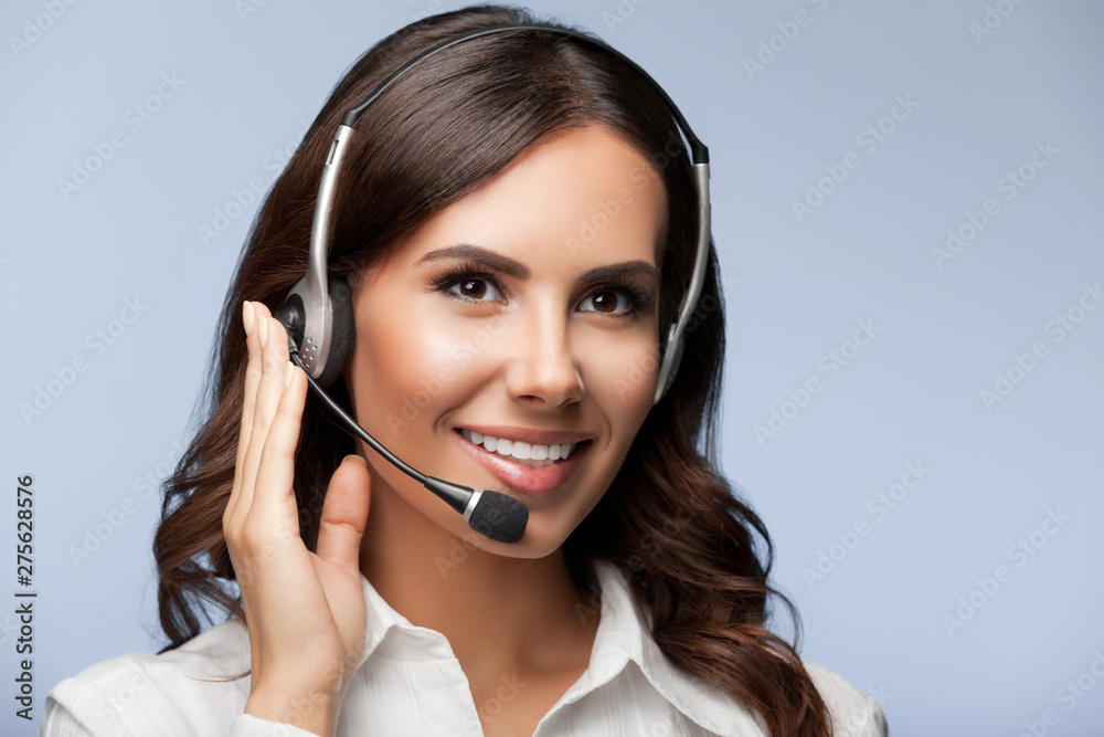 support female phone operator in headset, against grey support female phone operator in headset, against grey