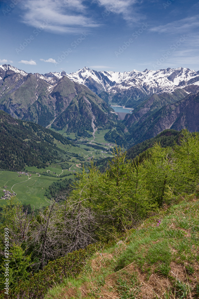 Panoramic view of the snow-capped peaks of the Alps in the upper Blenio valley in Switzerland, in spring.