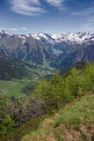 Panoramic view of the snow-capped peaks of the Alps in the upper Blenio valley in Switzerland, in spring.