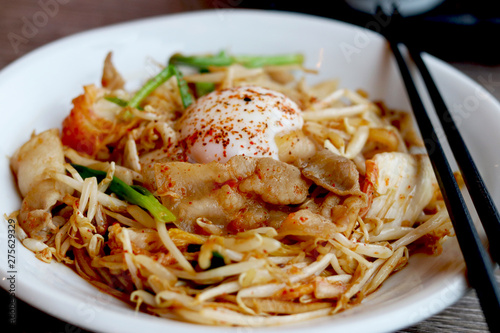 Buta Kimchi  (Pork and Kimchi Stir-fry with onsen tamago egg)  ,  a milder Japanese version of the Korean dish Jaeyook Bokkeum . photo