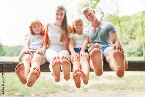 Family and children are sitting barefoot photo