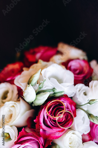 Close-up image of a beautiful and stylish wedding bouquet of white and pink flowers rose and rings. Top view  copy space