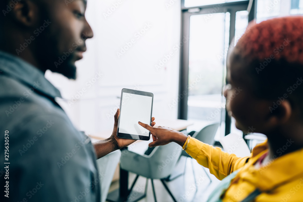 Black waiters using tablet in cafe Black waiters using tablet in cafe