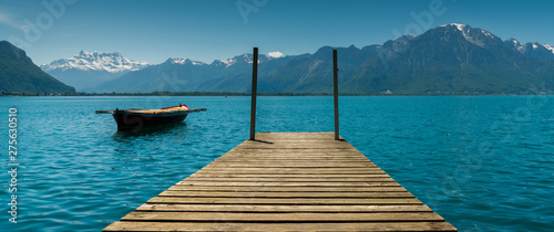 Canvas-taulu mountain and lake landscape with a vintage rescue rowboat and a wooden pier