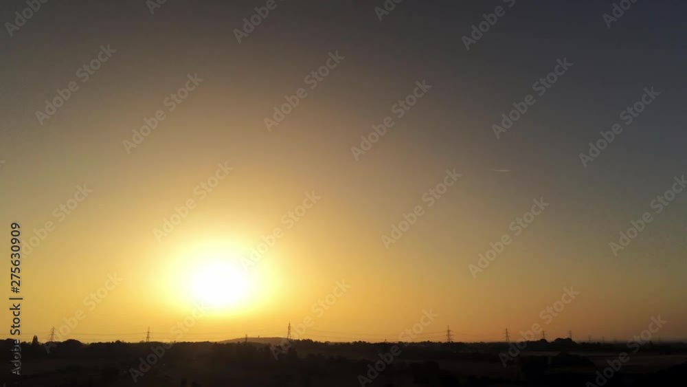 Golden hour sunrise tilt down to silhouette farmland landscape. Golden hour sunrise tilt down to silhouette farmland landscape.
