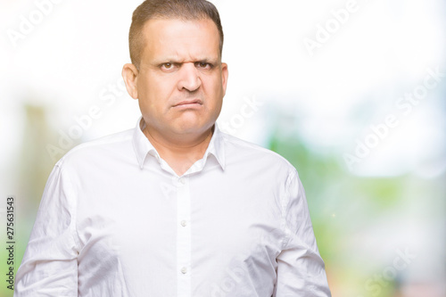 Middle age arab elegant man over isolated background skeptic and nervous, frowning upset because of problem. Negative person.