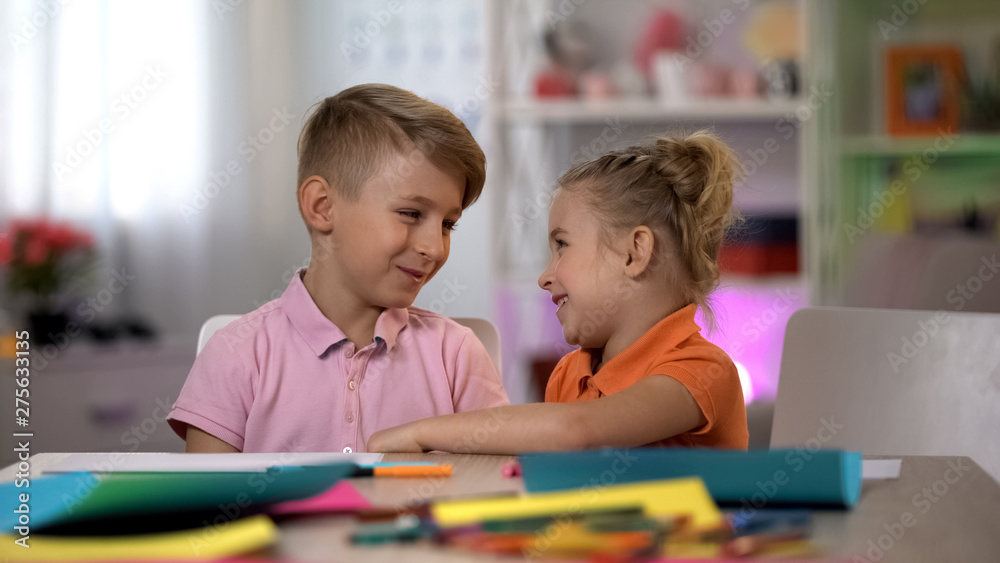Smiling brother and sister looking at each other, relationship of trust, family