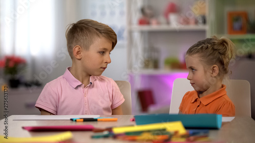 Fotografie Offended siblings looking at each other, children quarreling, misunderstanding