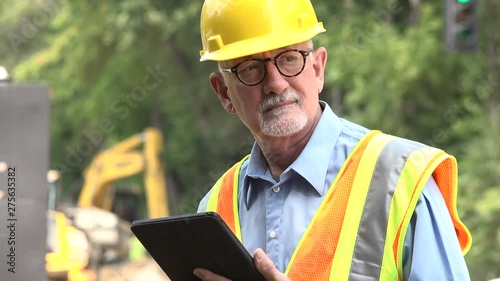 Man using his tablet/ipad on a construction site