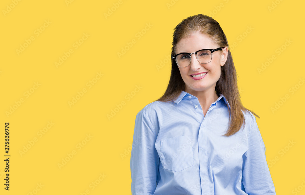 Beautiful middle age mature business woman wearing glasses over isolated background winking looking at the camera with sexy expression, cheerful and happy face.