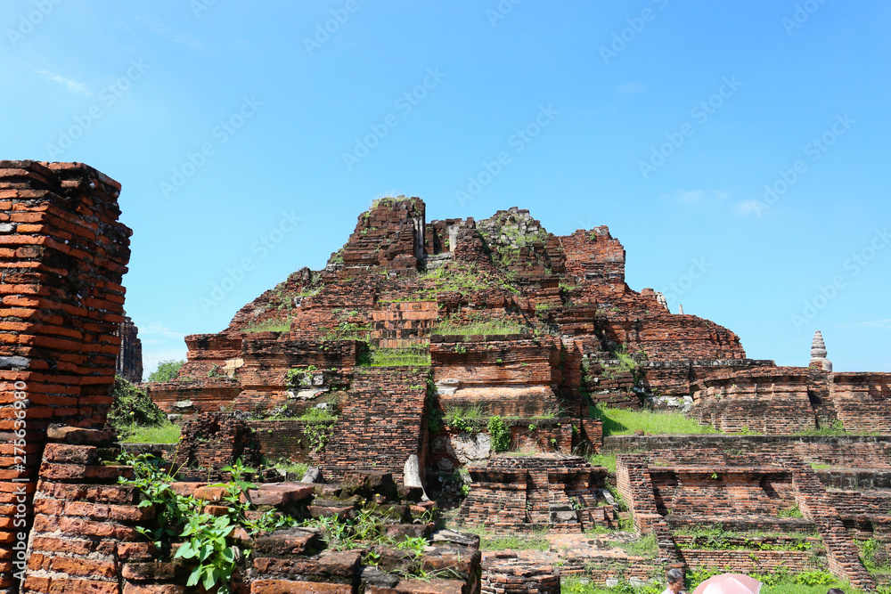 old ruins of Ayuttaya public temple in historical park with blue sky