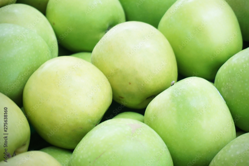 close up of regular shaped healthy and tasty green apples close up of regular shaped healthy and tasty green apples