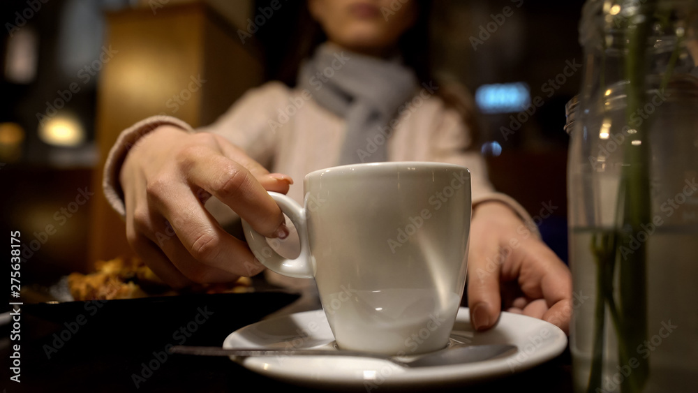 Young woman enjoying coffee in restaurant, free time alone, relaxation close up