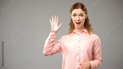 Deaf woman saying bye, asl teacher gesturing words in sign language, tutorial photo