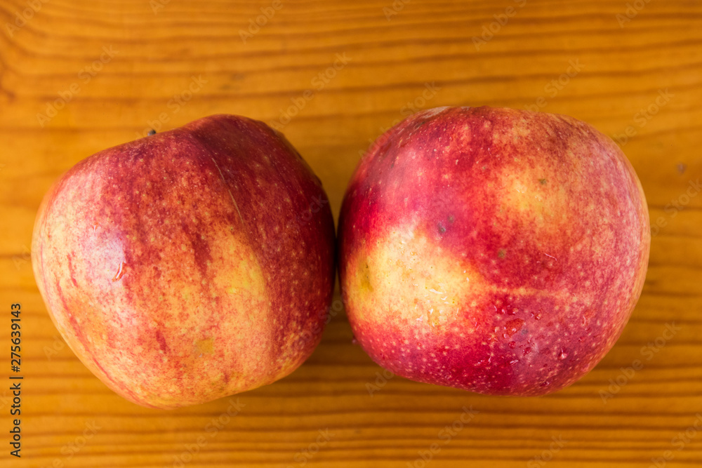two red apples on a wooden brown board, drops of water on an apple, texture, background, close-up, fruit two red apples on a wooden brown board, drops of water on an apple, texture, background, close-up, fruit