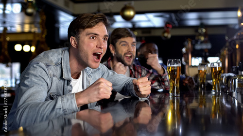 Male supporters watching sport program in bar celebrating victory, true men rest