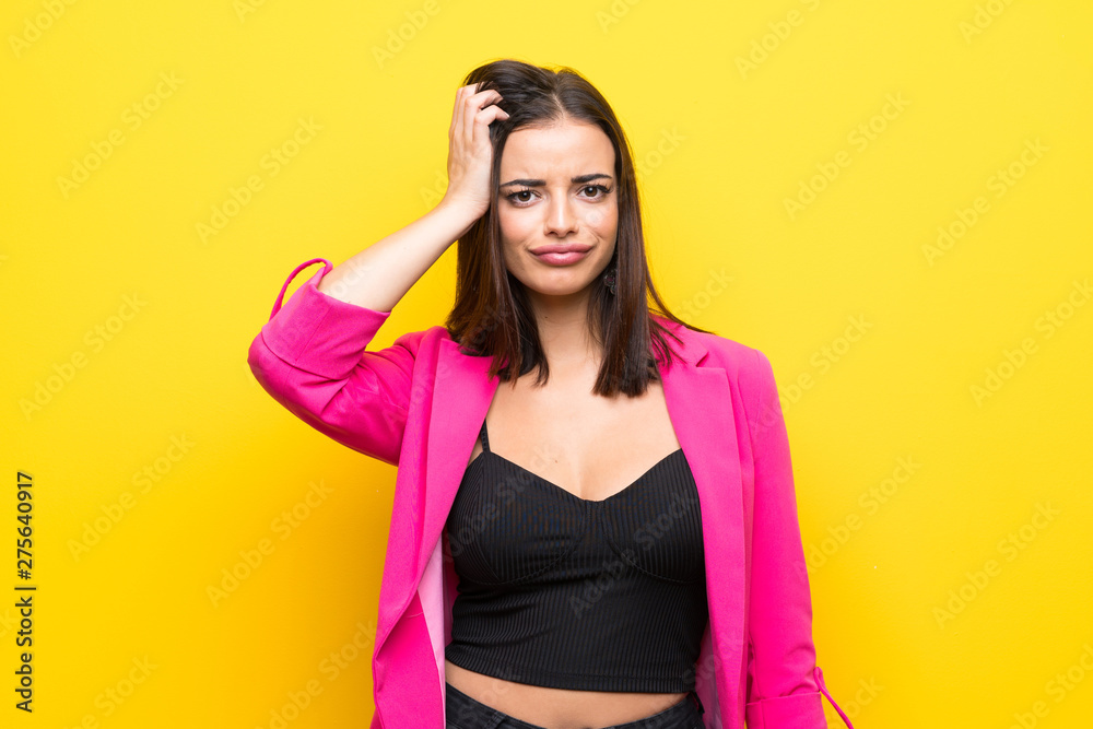 Young woman over isolated yellow background with an expression of frustration and not understanding Young woman over isolated yellow background with an expression of frustration and not understanding