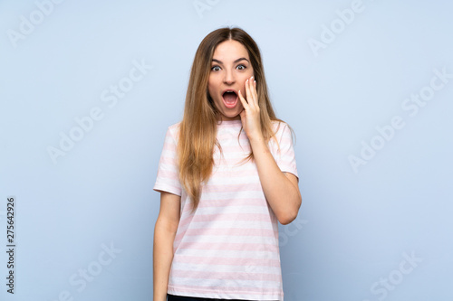 Young woman over isolated blue background with surprise and shocked facial expression
