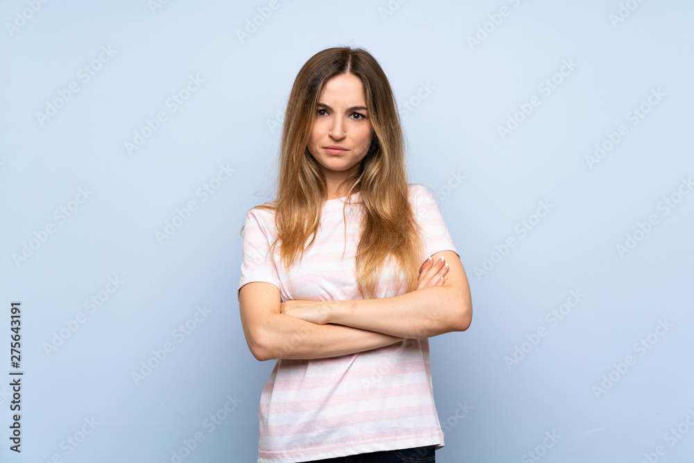 Young woman over isolated blue background feeling upset Young woman over isolated blue background feeling upset