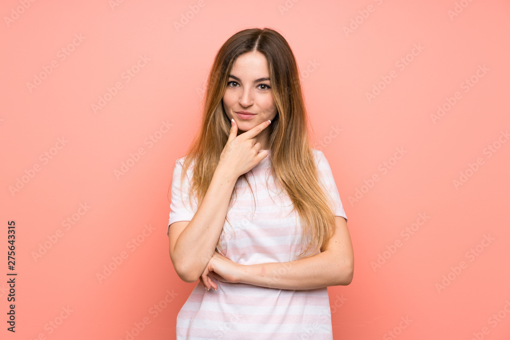 Young woman over isolated pink wall laughing