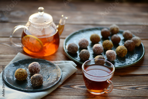 Tea in glass teapot, cup and energy balls