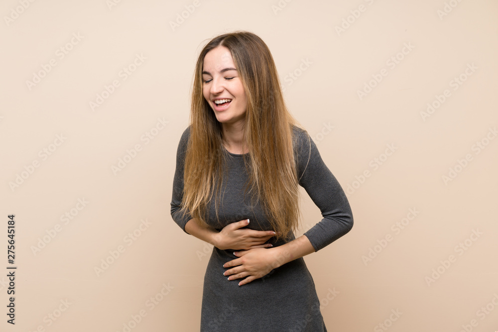 Young woman over isolated background smiling a lot Young woman over isolated background smiling a lot