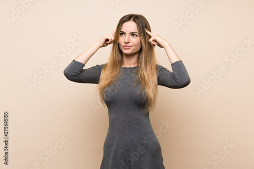 Young woman over isolated background having doubts and thinking