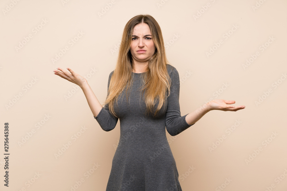 Young woman over isolated background unhappy for not understand something Young woman over isolated background unhappy for not understand something
