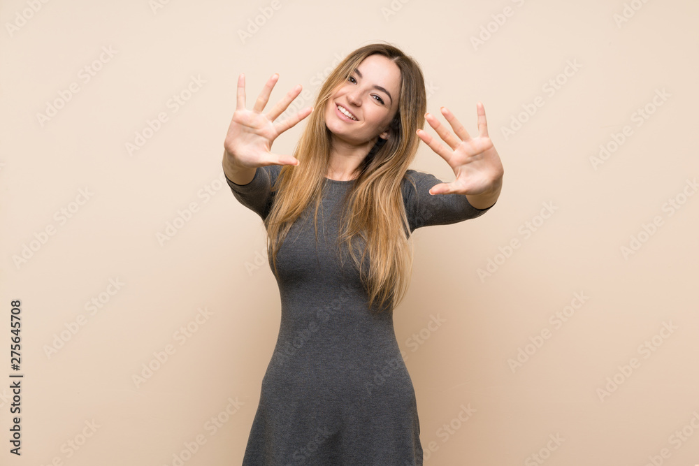 Young woman over isolated background counting ten with fingers Young woman over isolated background counting ten with fingers