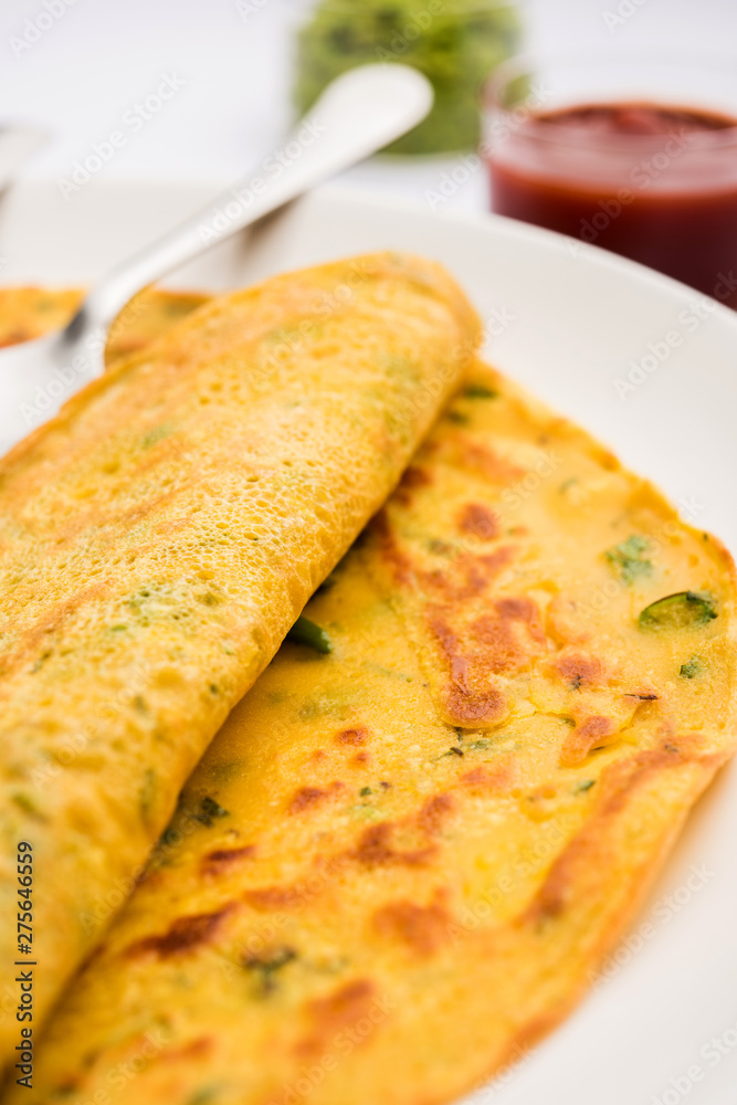 Chilla or Besan cheela is a simple pancake made with chickpea flour and some basic ingredients served with green chutney and tomato sauce, also known as veg-omelette Chilla or Besan cheela is a simple pancake made with chickpea flour and some basic ingredients served with green chutney and tomato sauce, also known as veg-omelette