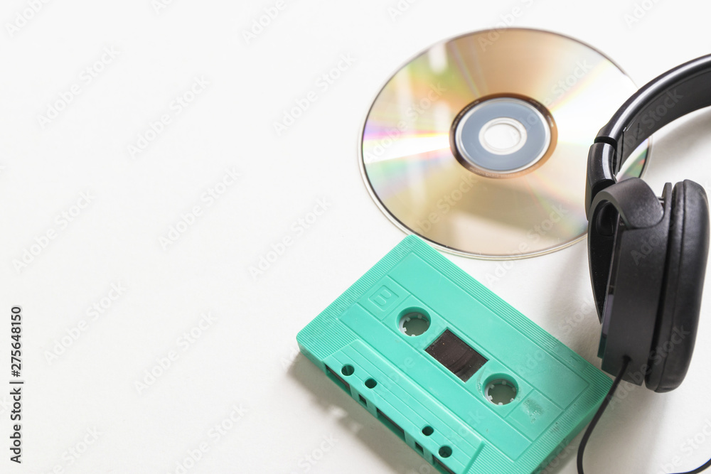 Compact disc; turquoise cassette and headphone over white background Compact disc; turquoise cassette and headphone over white background