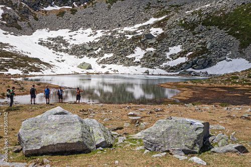 Hikers near the Panelatte Lake in Piedmont, Italy. photo
