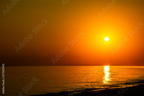 Horizontal sunset coastline calm sea with golden sun - Late afternoon on beach waterline with golden direct sunset calm sea ocean - Sun sky sea ocean night time