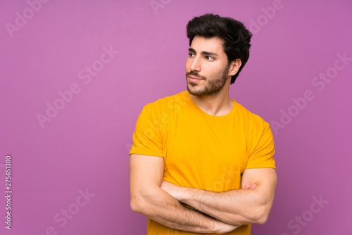 Handsome over isolated purple wall portrait