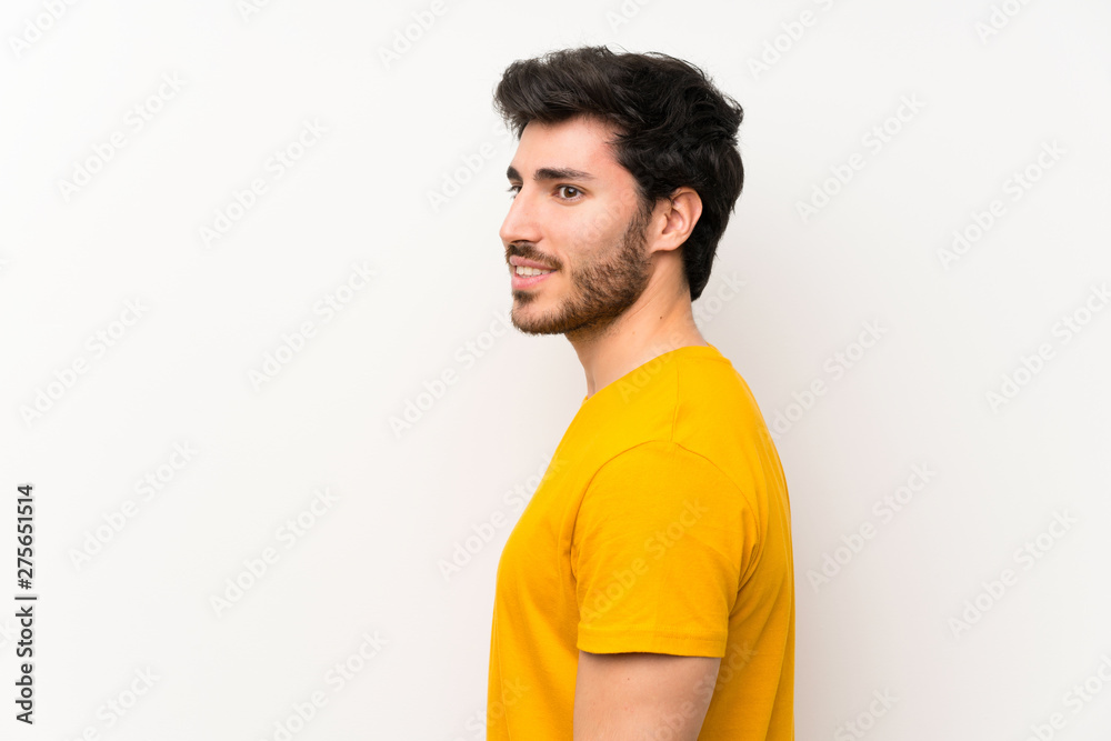 Handsome over isolated white wall standing and looking to the side Handsome over isolated white wall standing and looking to the side