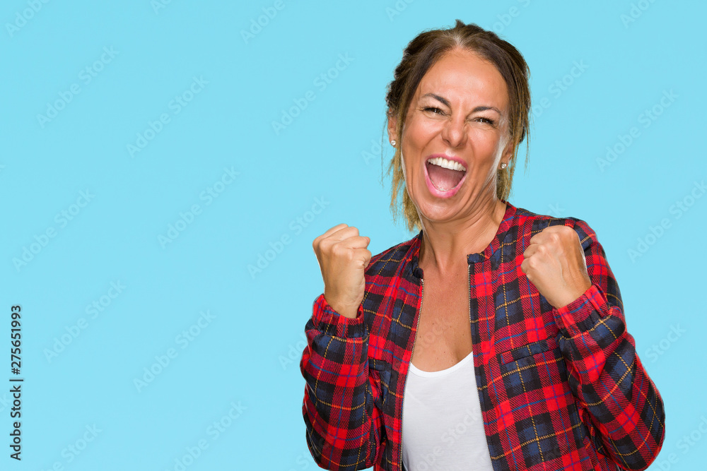 Middle age adult woman wearing casual jacket over isolated background very happy and excited doing winner gesture with arms raised, smiling and screaming for success. Celebration concept. Middle age adult woman wearing casual jacket over isolated background very happy and excited doing winner gesture with arms raised, smiling and screaming for success. Celebration concept.