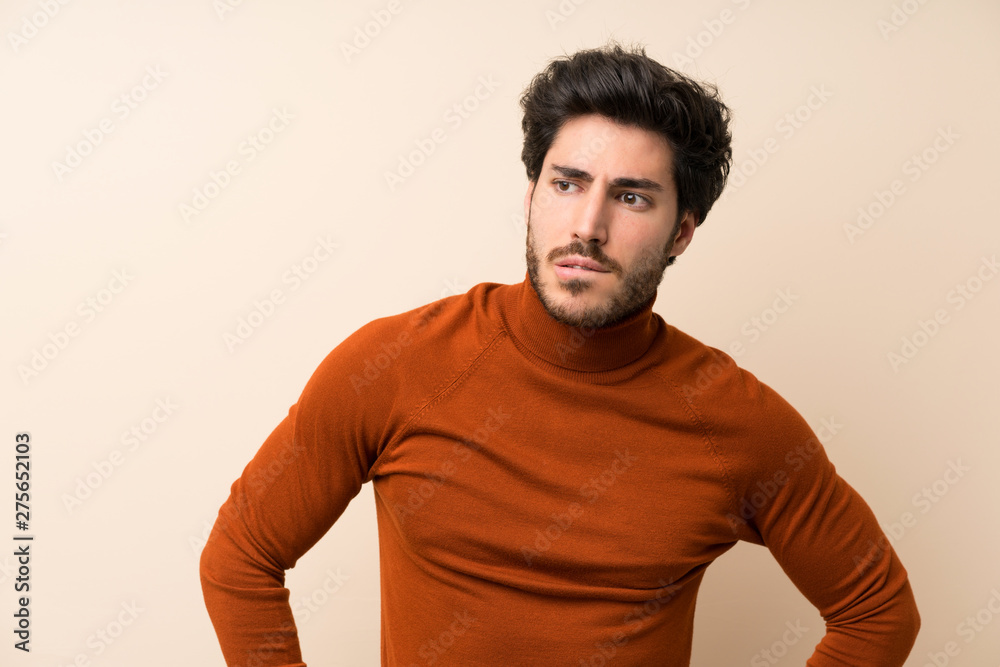 Handsome over isolated wall with confuse face expression Handsome over isolated wall with confuse face expression