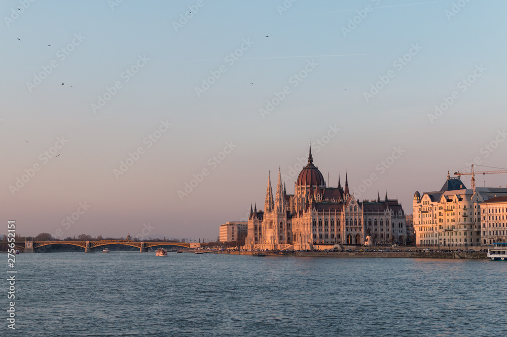 The Hungarian Parliament Building on the Danube River in Budapest, Hungary at sunset