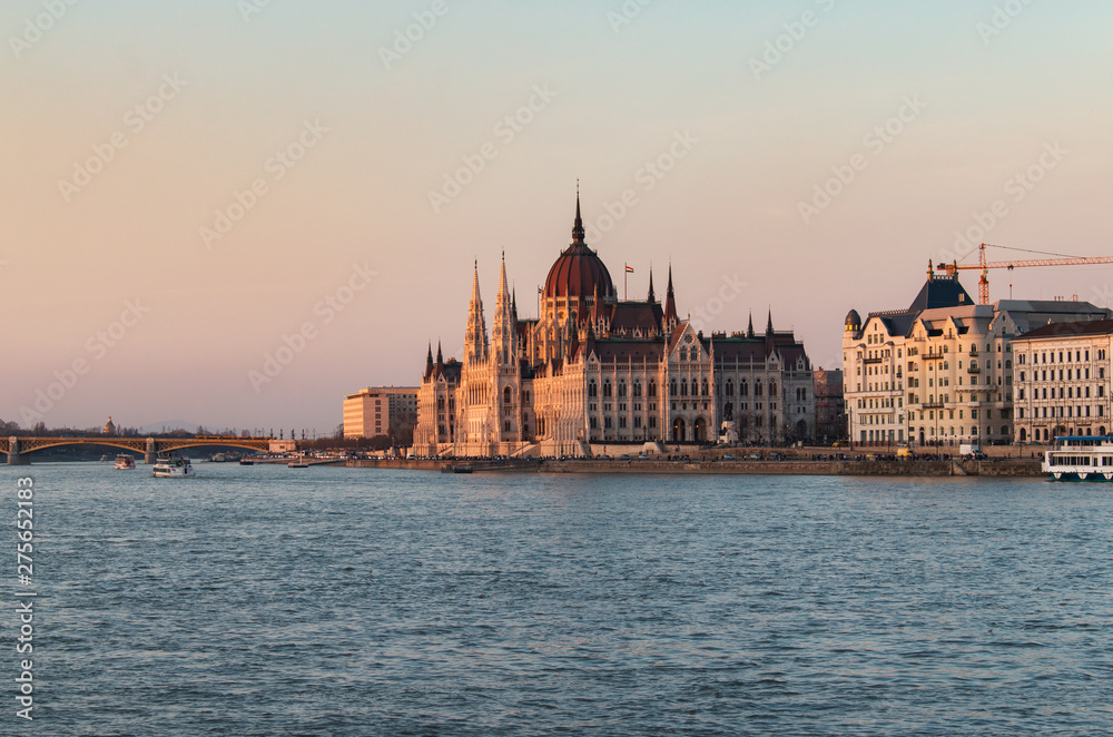 The Hungarian Parliament Building on the Danube River in Budapest, Hungary at sunset
