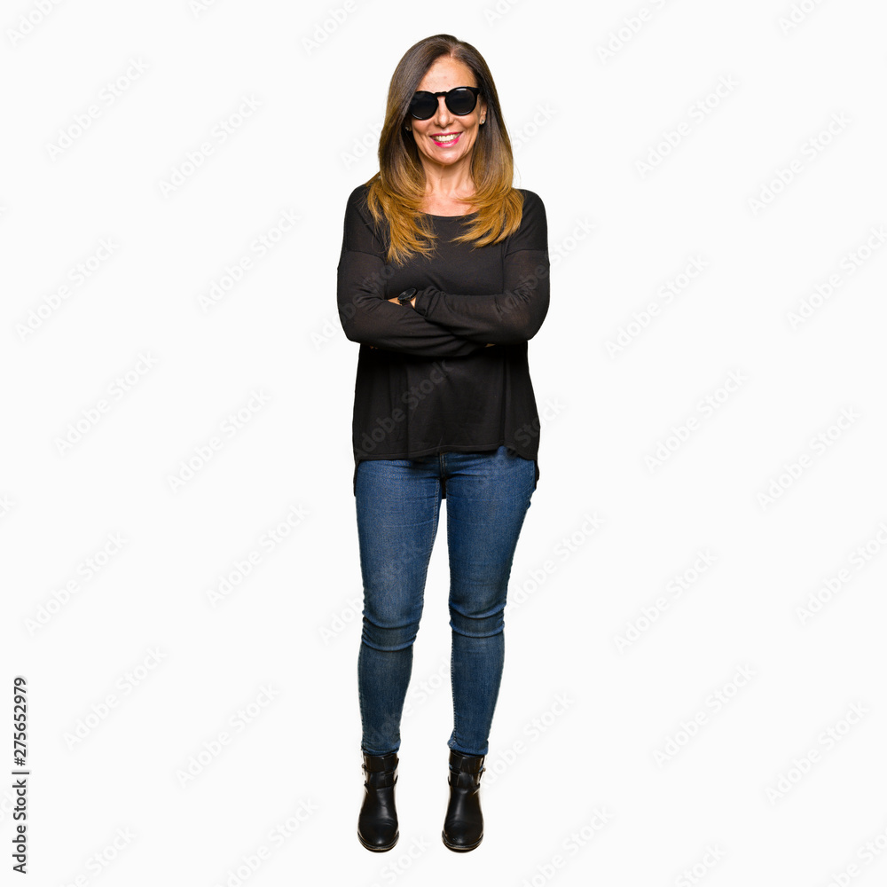 Beautiful middle age woman wearing sunglasses happy face smiling with crossed arms looking at the camera. Positive person. Beautiful middle age woman wearing sunglasses happy face smiling with crossed arms looking at the camera. Positive person.