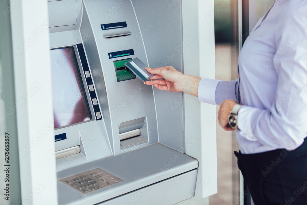 Business woman using ATM. Person using credit card to withdrawing money from atm machine. Business woman using ATM. Person using credit card to withdrawing money from atm machine.