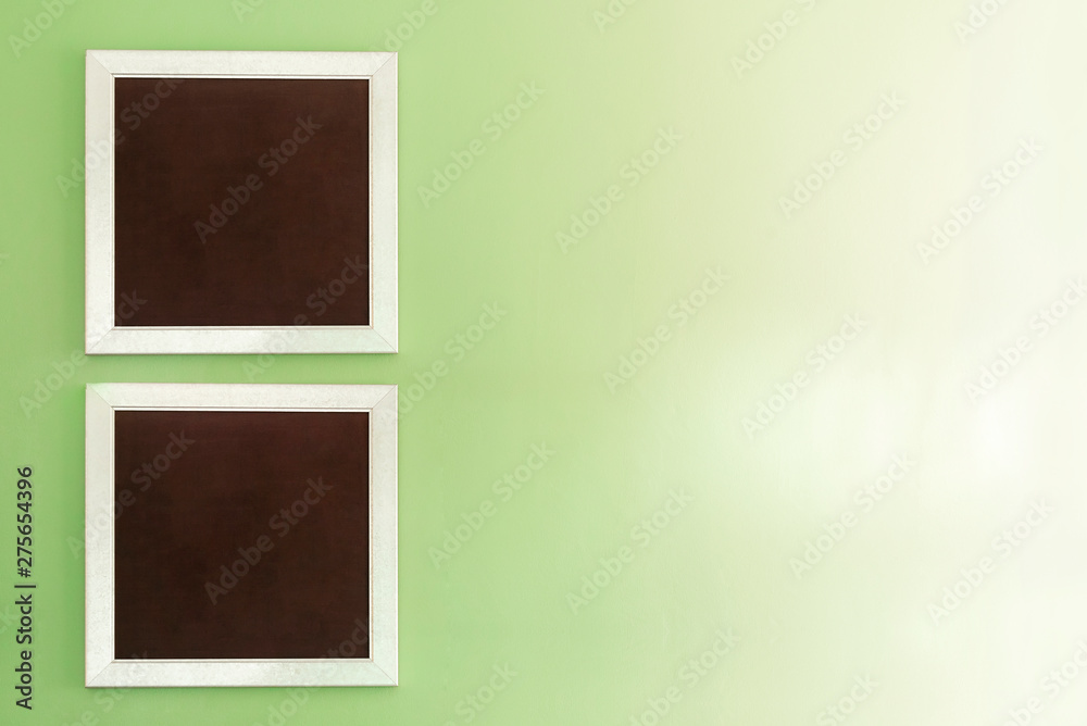 Empty photo frames on green wall with free space background. Empty photo frames on green wall with free space background.