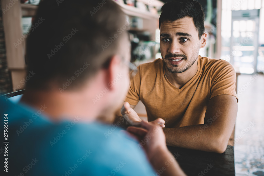 © BullRun - Serious male colleagues discussing information for startup project sitting at cafeteria table and feeling confused on fresh ideas, Caucasian men brainstorming togetherness in coworking space © BullRun - Serious male colleagues discussing information for startup project sitting at cafeteria table and feeling confused on fresh ideas, Caucasian men brainstorming togetherness in coworking space